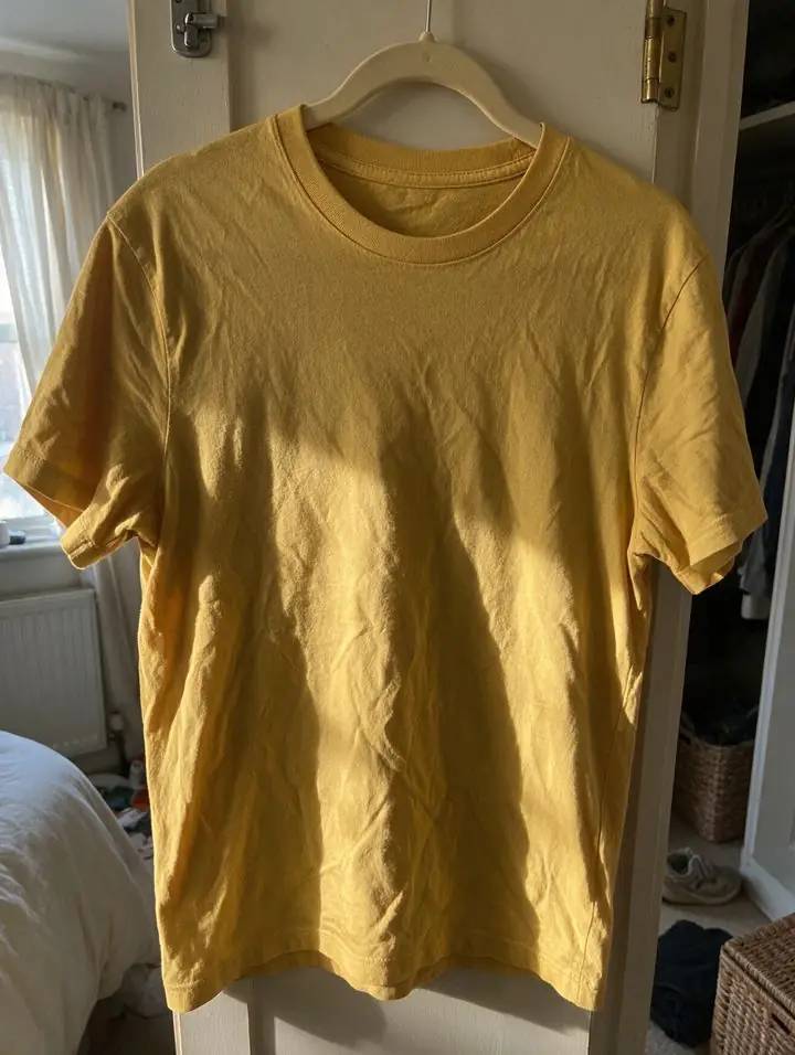 Before: phone photo of a sample t-shirt hanging on a door